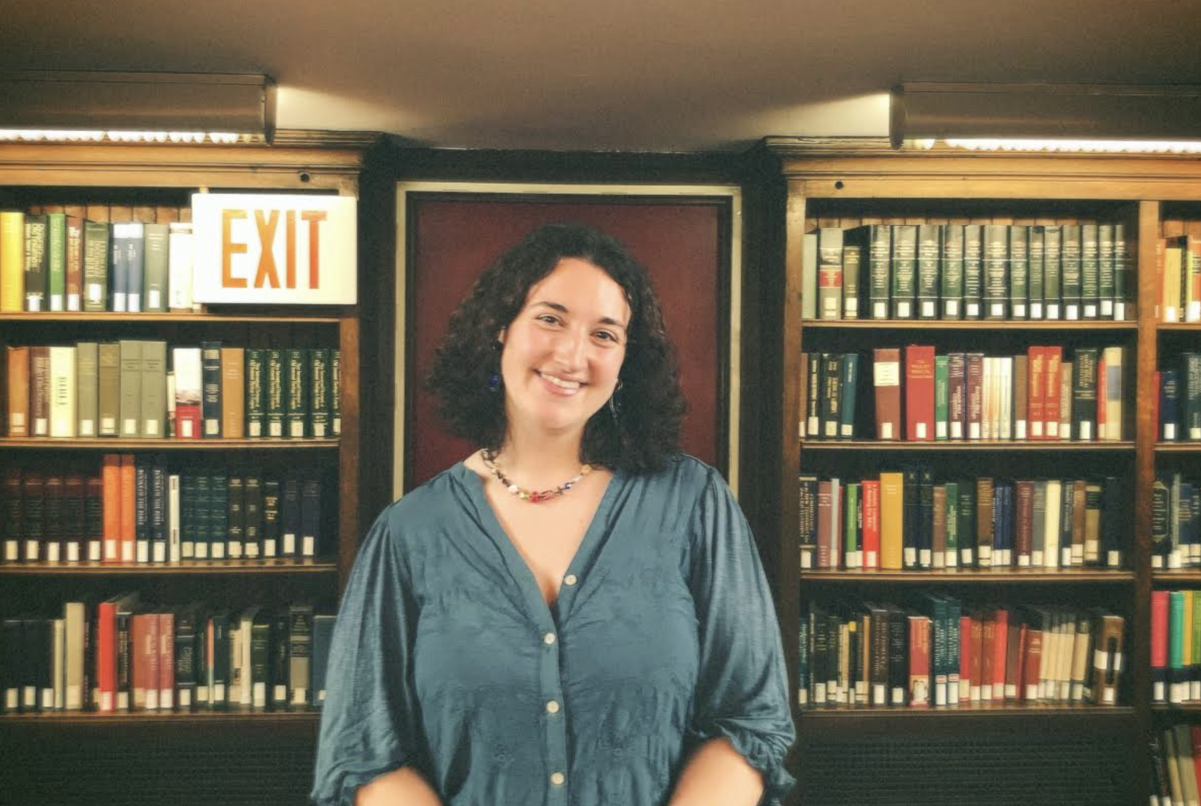 Headshot of student Haley Planicka smiling in front of bookshelves